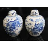 A pair of Chinese blue and white miniature vases with covers, each bearing six character Kangxi mark
