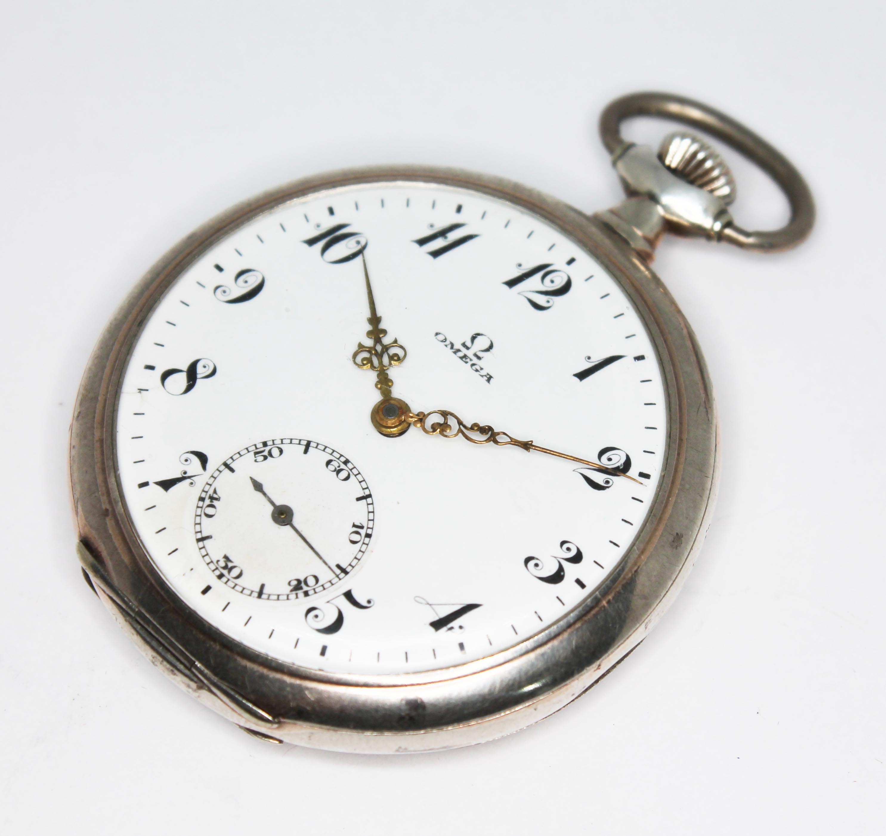 A 1920s Omega silver cased open face pocket watch, the signed white enamel dial having ornate Arabic