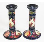 A pair of Moorcroft pottery candelsticks, height 21cm, with boxes.