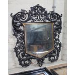 A Victorian cast iron shield shaped mirror 75cm x 87cm.