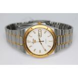 A two tone stainless steel Seiko 5 7S26-0100 automatic day date wristwatch with signed white dial,