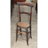 A 19th century bergere seated child's correction chair.