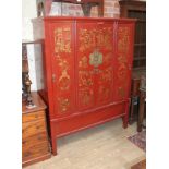 A large Chinese red lacquer cabinet.