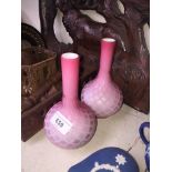 A pair of bonhemian pink and white cased glass vases.