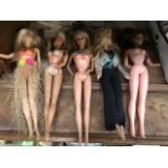 Five dolls including two 1960s Mattel Barbie dolls, one 1990s Mattel Barbie doll and two others