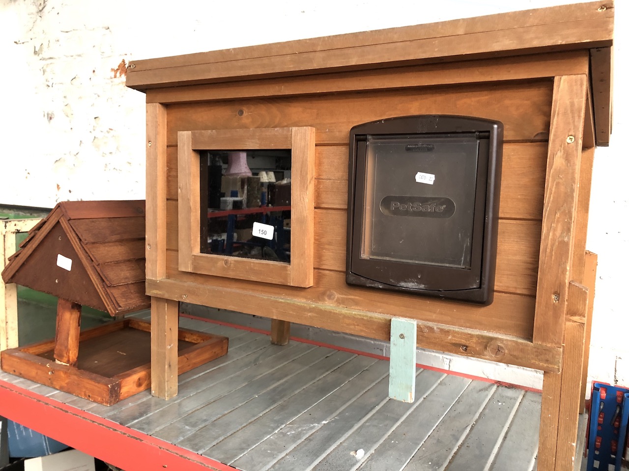 A pet hutch and wooden bird house