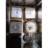 A small selection of alarm clocks and a pocket watch.