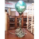 A brass figural lamp with Brierley spherical glass shade.
