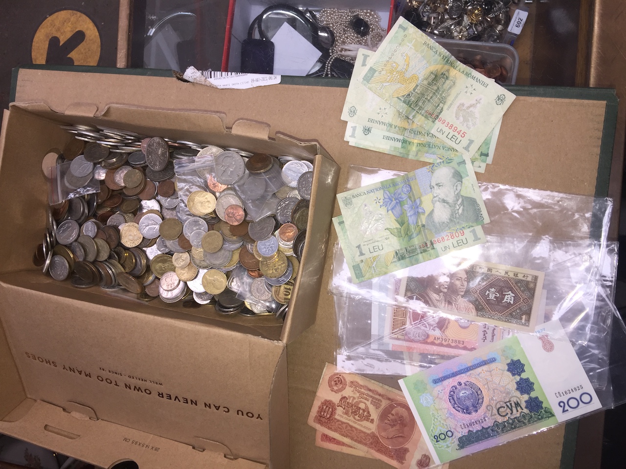 A box of world coins and banknotes.