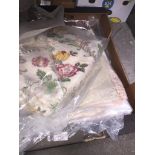 A box of textiles including lace and embroidery etc