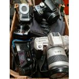 A box of cameras to include Minolta Dynax 404si and Panasonic Lumix DMC-FZ18.
