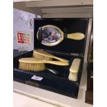 An ivory grooming kit, boxed, together with a number of horn spoons