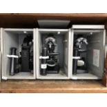 Three cased microscopes