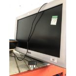 A Panasonic 22" white LCD TV with remote