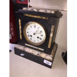 A black slate and marble mantle clock with pendulum