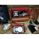 Box with five vintage cameras and a pair of binoculars