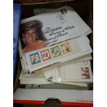 A box of first day covers and postcards