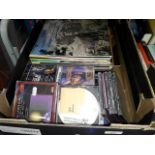 A box of CDs and LPs