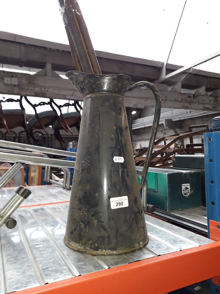 An enameled tin jug and 4 walking sticks.