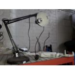 A metal angle poise magnifying lamp and another angle poise lamp with heavy metal base