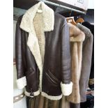 A full length sheepskin coat, a full length mink coat, and a repro flying jacket