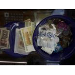 A tub of world coins and bank notes