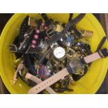 A yellow tub of gents & ladies wristwatches.