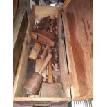 A wooden box containing a large quantity of woodworking tools