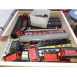 A box of assorted "00" gauge model railway trucks and carriages including spares.