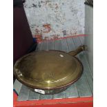 A brass warming pan