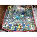 A tin containing approx. 400+ marbles, various sizes and types.