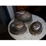 A set of three silver plated domed cloches.