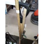 A bundle of garden tools including rake, hoe etc