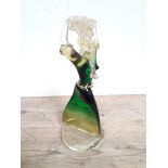 A Venetian green and clear glass figure modelled as a woman carrying a bundle of twigs above head,