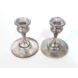 A pair of Art Nouveau style hallmarked silver candle sticks, height 10cm, as found.
