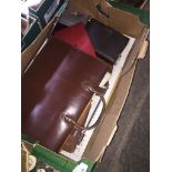 A vintage leather music case and other leather goods.