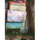 A box of jigsaw puzzles and 4 completed jigsaws