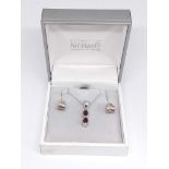 A Kit Heath garnet pendant, chain length 40cm, marked '925' with a pair of similar earrings, boxed.