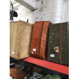 A vintage leather suitcase, vintage Velum case and vintage army style case.