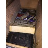 A box of collectables to include AA car badge, GB sign, dominoes, old folding camera, penknives,