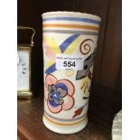 A Poole Pottery red bodied vase of cylindrical form and painted with stylised flowers, impressed and