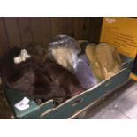 A box of fur hats, corduroy hats and a fur stole.