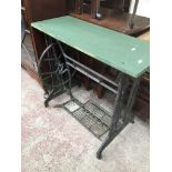 A garden table made from old treadle sewing machine base