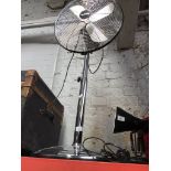 A Holmes chromed oscillating pedestal fan.