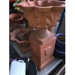 2 acanthus planters - one on small plinth and one on large plinth.