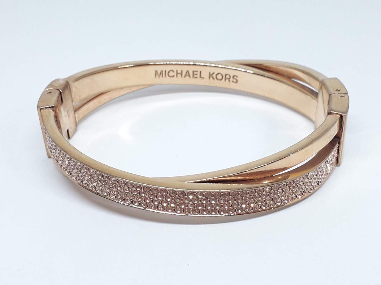 A Michael Kors gold plated bangle, diam. approx. 60mm.