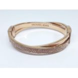 A Michael Kors gold plated bangle, diam. approx. 60mm.