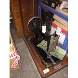 A vintage Vesta boat shuttle sewing machine in original wooden case, with key and manual.