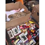 A box of dolls and a box of die cast and other model vehicles