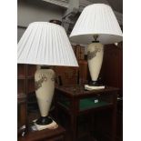 A pair of modern cream pottery table lamps